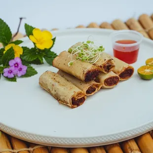 Crispy Lumpia or fried spring rolls with minced chicken meat, carrots, celery, onion and garlic served with sweet-chili sauce.