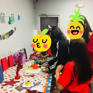 a group of people standing around a table