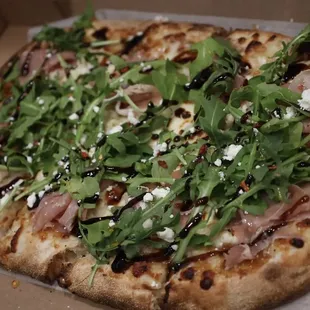 Fig and Prosciutto: Fig spread, Mozzarella, Goat Cheese, Prosciutto, Arugula, Hot honey, Balsamic Drizzle, Crushed Red Pepper
