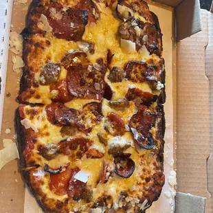 a pizza in a cardboard box