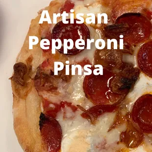a close up of a pepperoni pizza