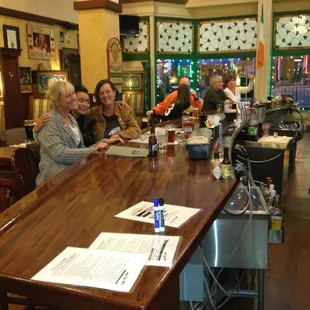 Nice long wooden bar with  large HD TVs.