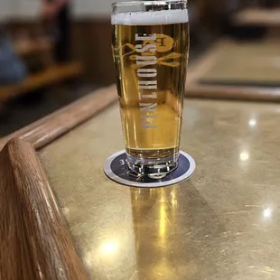 a pint of beer on a table