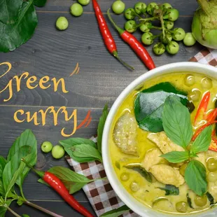 a bowl of green curry with vegetables