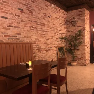 the dining area with a brick wall