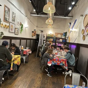 people sitting at tables in a restaurant