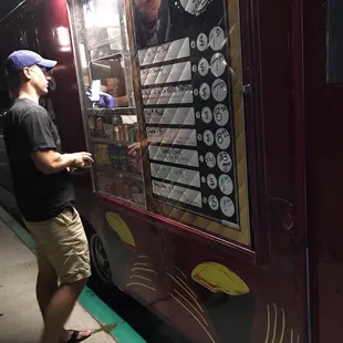 a man standing in front of a food truck