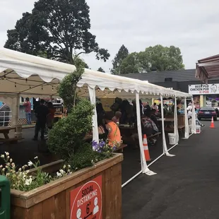 a group of people sitting under a tent