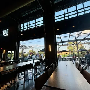 Indoor/ outdoor space with big tables for groups