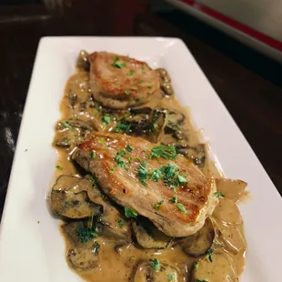 Pork Tenderloins over a creamy porcini mushroom sauce