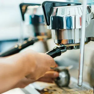 a person using a coffee machine