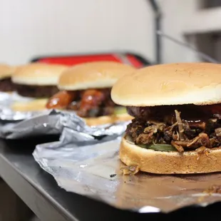 two burgers on tin foil