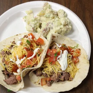 two tacos on a white plate
