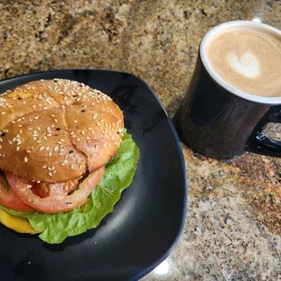 a hamburger and a cup of coffee