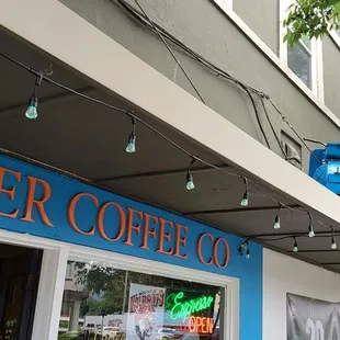 two people sitting outside a coffee shop