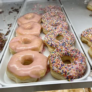 a variety of doughnuts in a display case