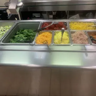 a salad bar with a variety of salads