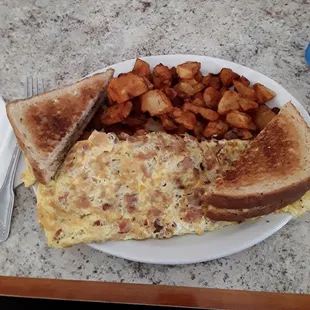 Bacon omelet with american fries and toast.