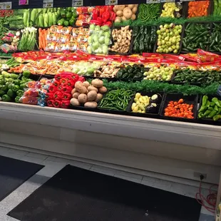 a display of vegetables and fruits