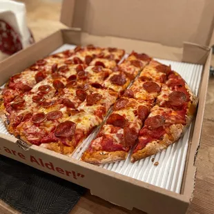 a pepperoni pizza in a box