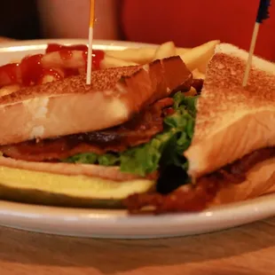 a sandwich with pickles and ketchup