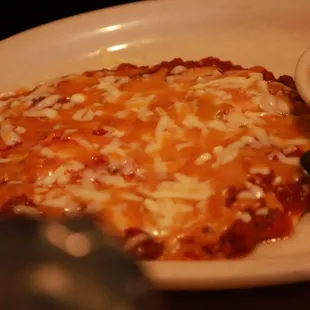 a plate of food with beans and cheese