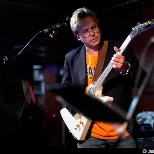 a man playing an electric guitar