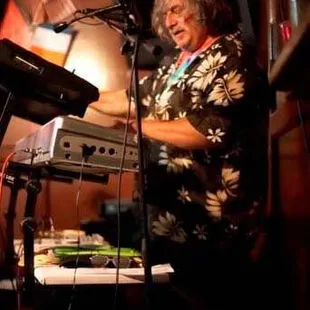 a man playing a keyboard and singing into a microphone