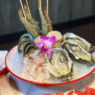 a plate of oysters with a flower