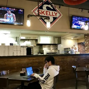 a man sitting at a table with a laptop