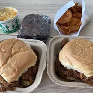 two trays of pulled pork and potato chips