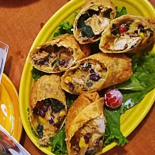 a plate of burritos on a table