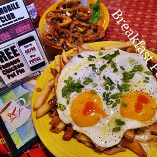 fried eggs and fries on a yellow plate