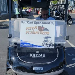 a man driving a golf cart