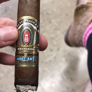 a cigar being held by a person