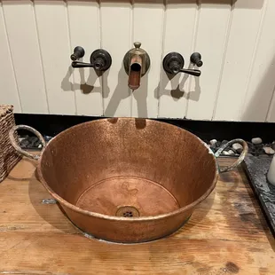 Bathroom sink  had neat design.