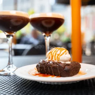 a chocolate cake with ice cream and caramel sauce