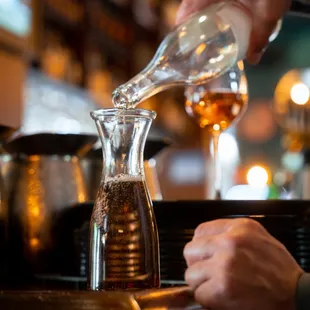 a person pouring a drink