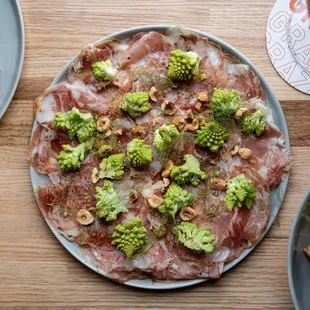 a pizza with broccoli on a plate