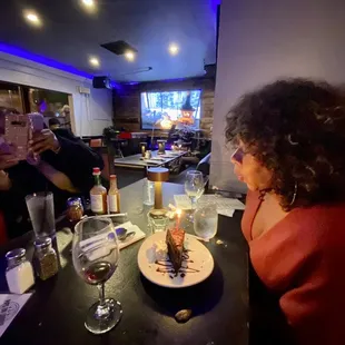 a woman sitting at a table in a restaurant