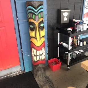 a painted tiki on a wall