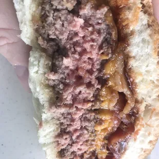 a hand holding a sandwich