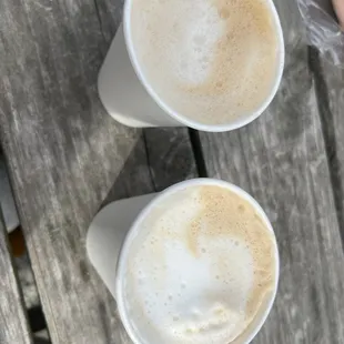 two cups of coffee on a picnic table