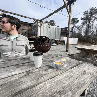 a man sitting at a picnic table