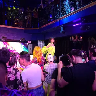 a crowd of people watching a performer on stage