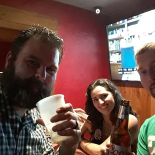 three men and a woman drinking beer