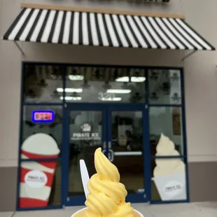 a hand holding a cup of ice cream