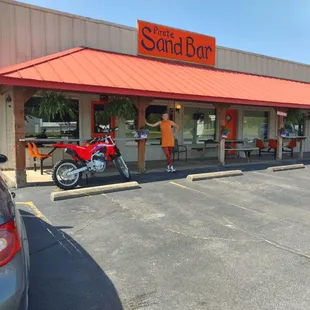 a motorcycle parked in front of the restaurant
