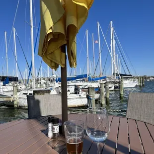 a table with two glasses of wine and an umbrella