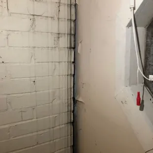 Beds were placed next to a window with a lot of spider webs.